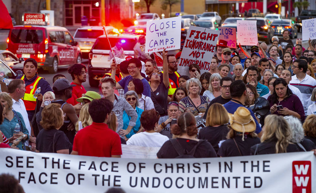 Advocates, activists and impacted persons gather for protest chants during Lights for Liberty: ...