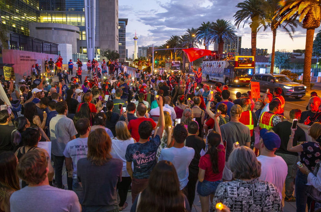 Advocates, activists and impacted persons hold lit candles and yell protest chants during Light ...