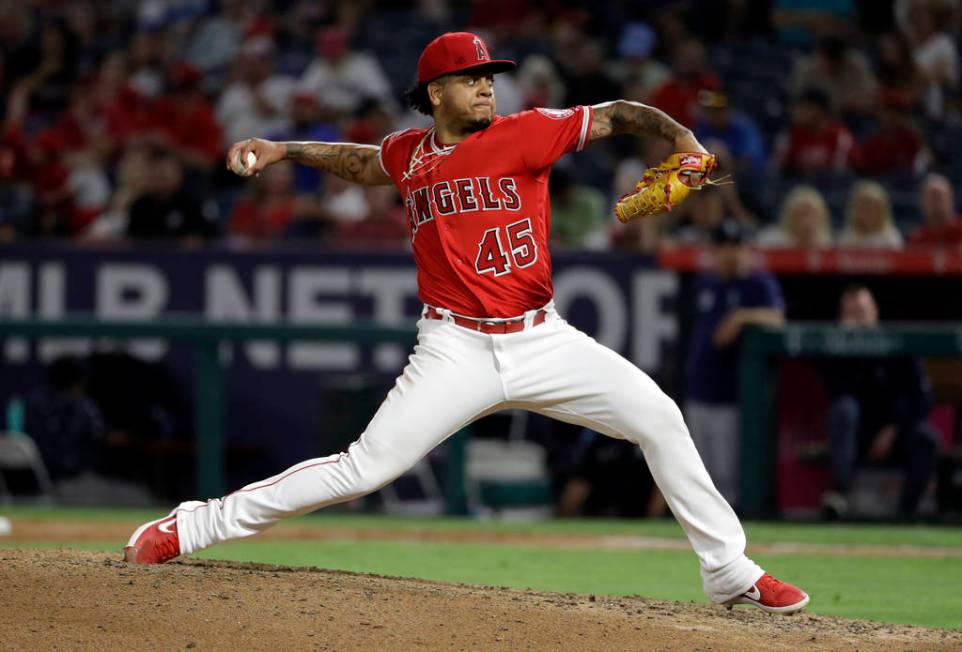 Los Angeles Angels relief pitcher Felix Pena throws to a Seattle Mariners batter during the six ...