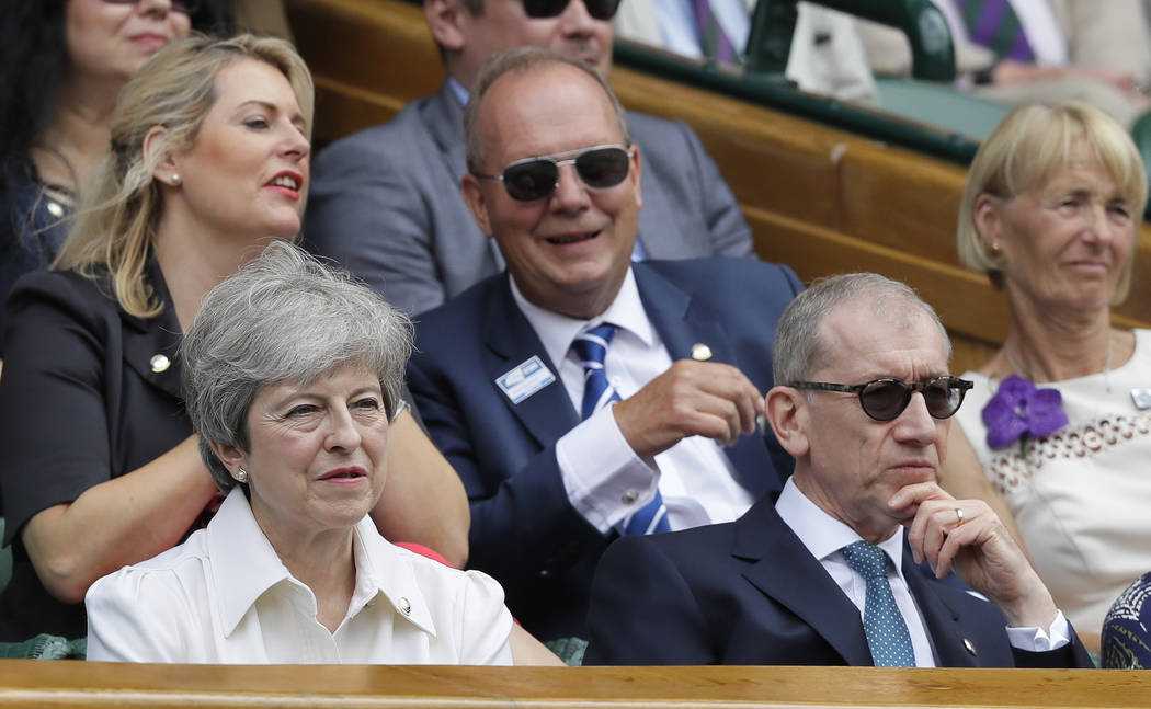 British Prime Minister Theresa May and her husband Philip sit in the Royal Box on Centre Court ...