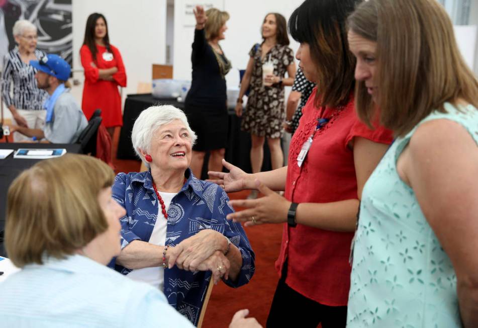 Longtime volunteers Cam Camburn, from left, and Barbara Ciocca, of Las Vegas, visit with Volunt ...