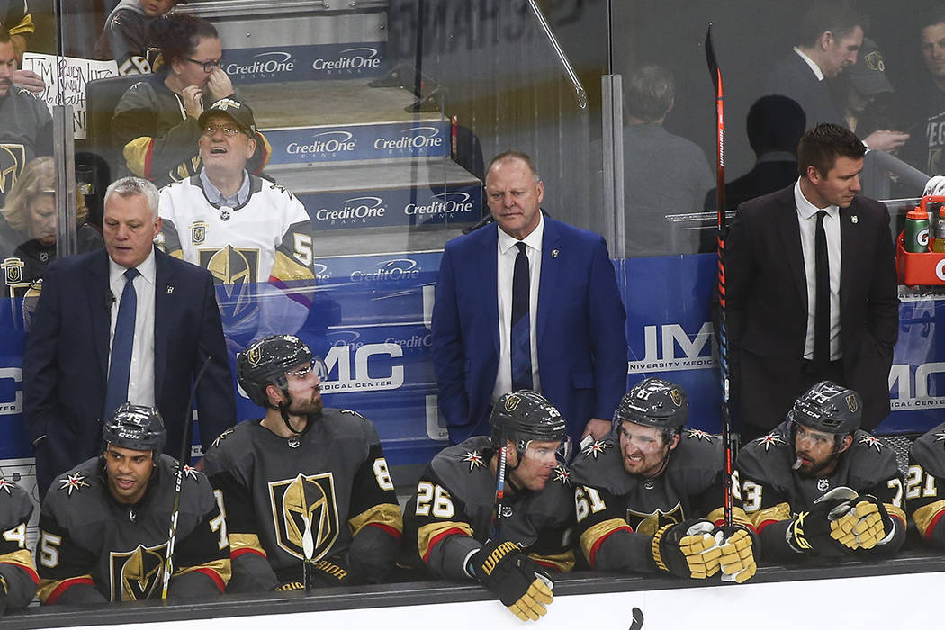 Golden Knights head coach Gerard Gallant, in blue, looks on during the third period of an NHL h ...