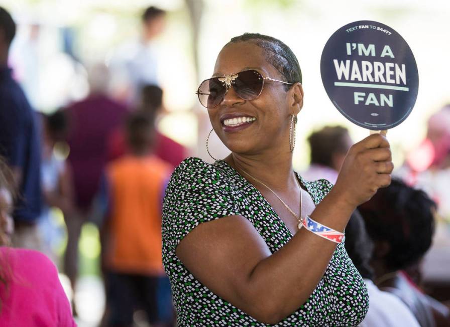 Lesha Lucas holds a sign for democratic presidential candidate Sen. Elizabeth Warren, D-Mass., ...