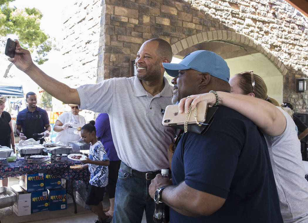 Nevada Attorney General Aaron Ford, left, takes selfies with guests during the 5th Annual Commu ...