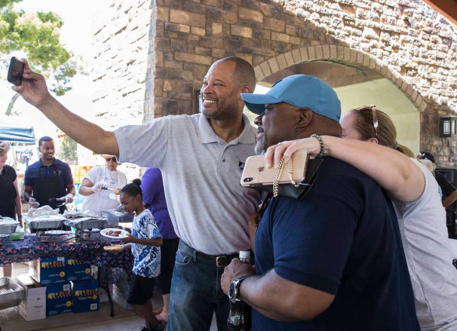 Nevada Attorney General Aaron Ford, left, takes selfies with guests during the 5th Annual Commu ...