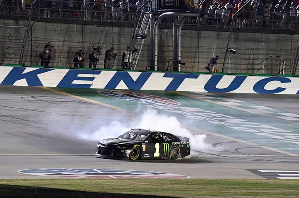 Kurt Busch does a burnout following his victory in the NASCAR Cup Series auto race at Kentucky ...