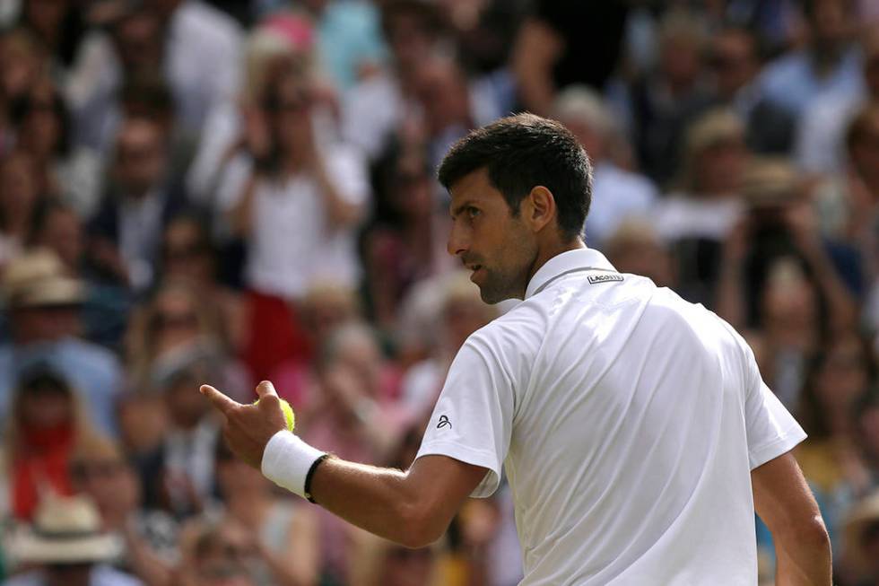 Serbia's Novak Djokovic celebrates winning a point against Switzerland's Roger Federer during t ...