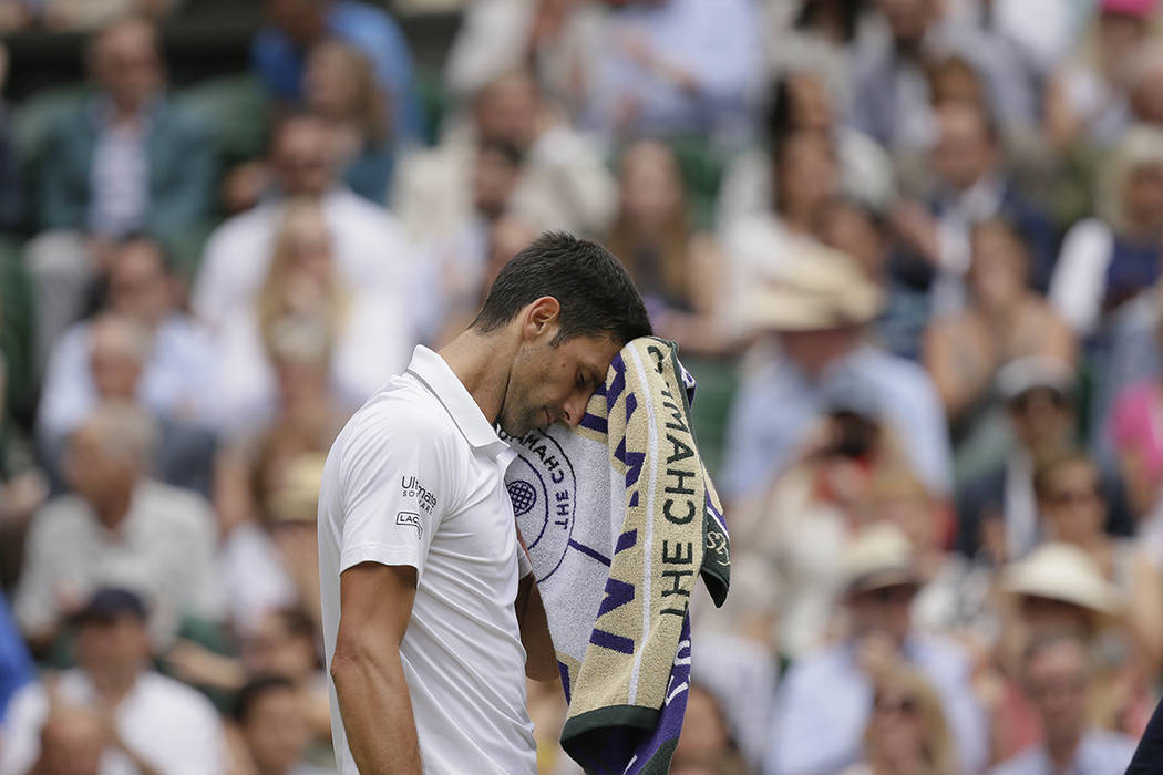 Serbia's Novak Djokovic is dejected after losing a point to Switzerland's Roger Federer during ...