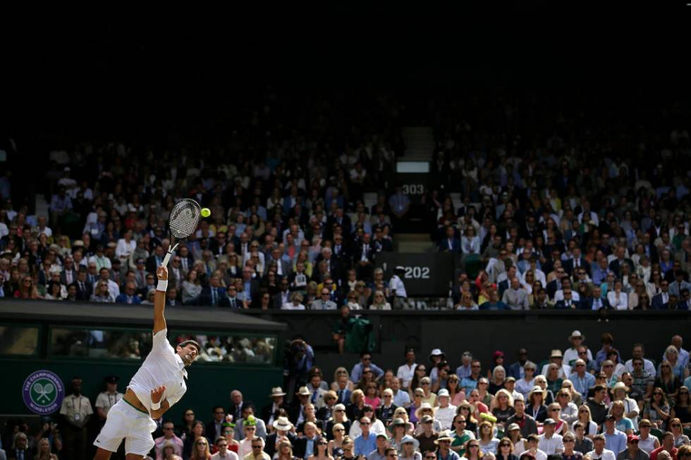 Serbia's Novak Djokovic serves to Switzerland's Roger Federer during the men's singles final ma ...