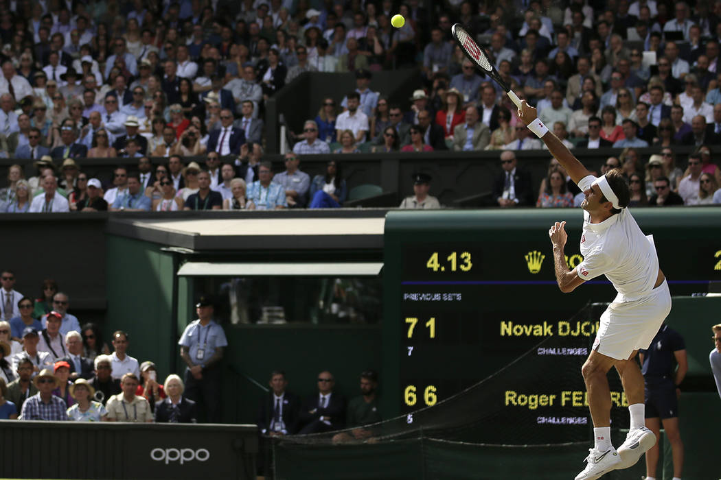 Switzerland's Roger Federer serves to Serbia's Novak Djokovic during the men's singles final ma ...