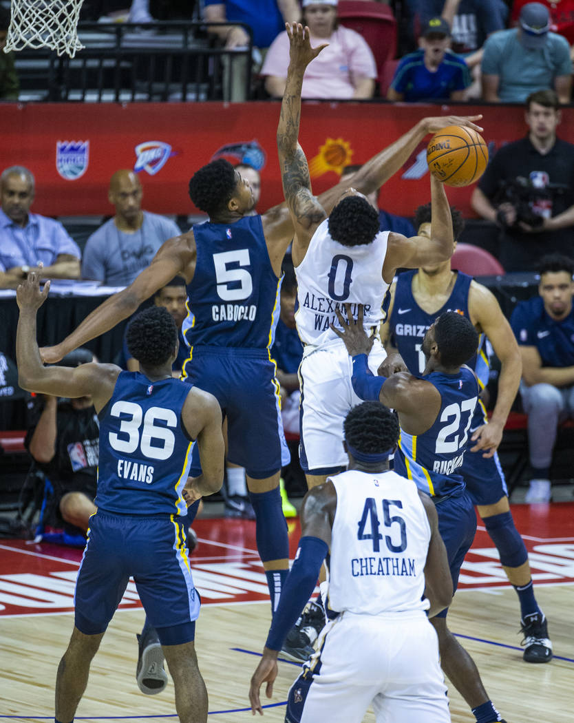 Memphis Grizzlies forward Bruno Caboclo, left, blocks a shot by New Orleans Pelicans guard Nick ...