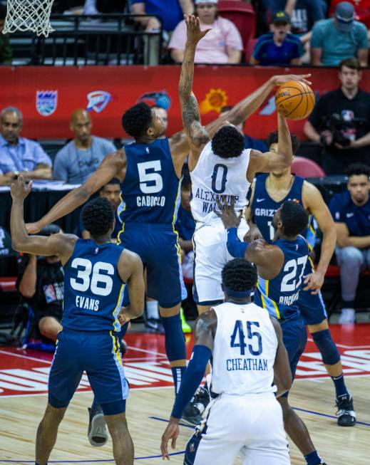 Memphis Grizzlies forward Bruno Caboclo, left, blocks a shot by New Orleans Pelicans guard Nick ...