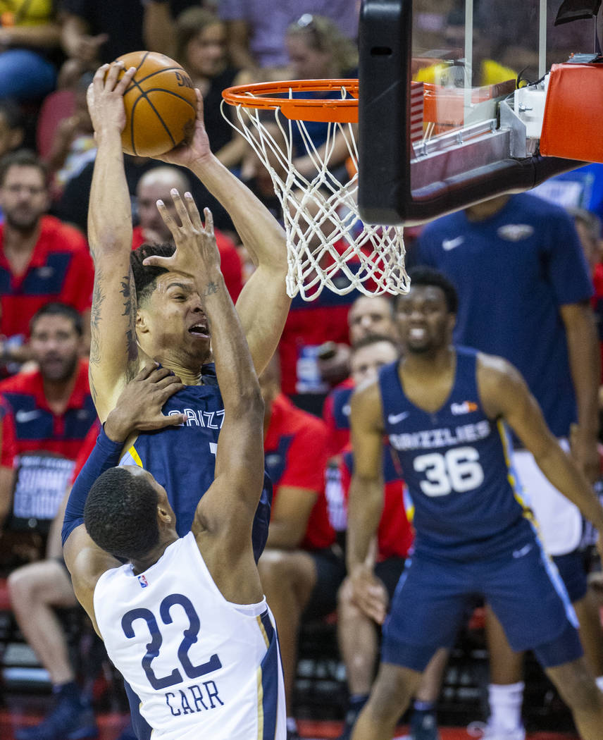 Memphis Grizzlies forward Brandon Clarke, left, goes unstrung to the basket over New Orleans Pe ...