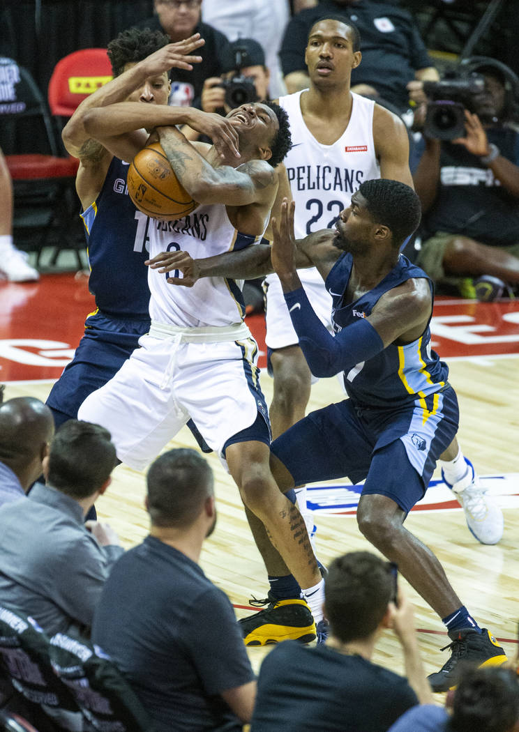 New Orleans Pelicans guard Nickeil Alexander-Walker, center, fights to keep the ball from Memph ...