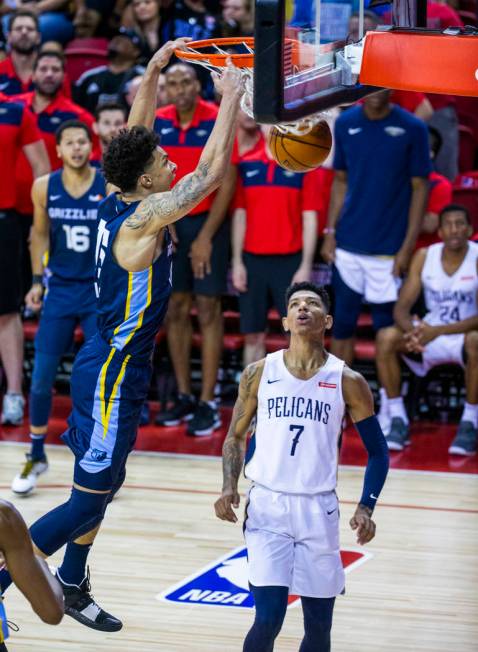 Memphis Grizzlies forward Brandon Clarke, left, dunks the ball late as New Orleans Pelicans for ...