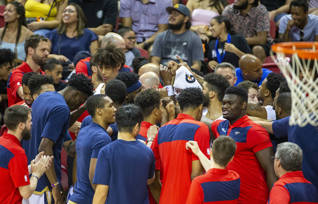 New Orleans Pelicans forward Zion Williamson, right, joins his teammates in huddle versus the M ...