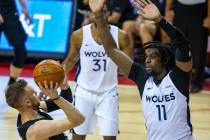 Brooklyn Nets guard Dzanan Musa, left, falls back on a shot attempt as Minnesota Timberwolves c ...