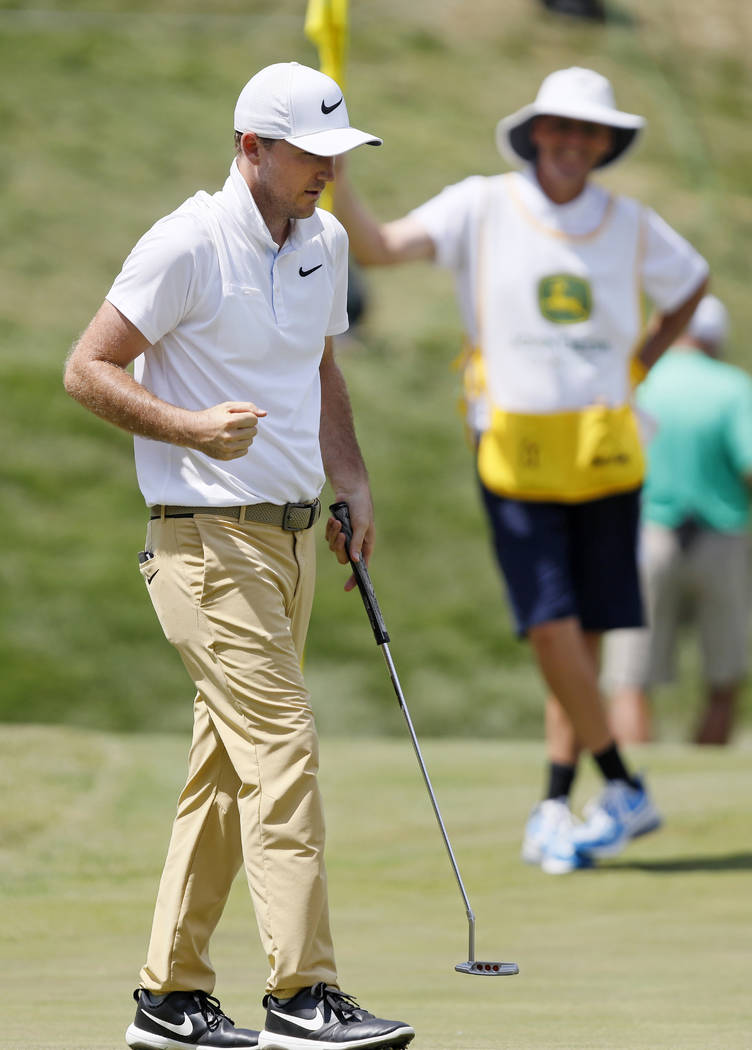 Russell Henley pumps his fist after making his birdie putt on the 18th green during the final r ...