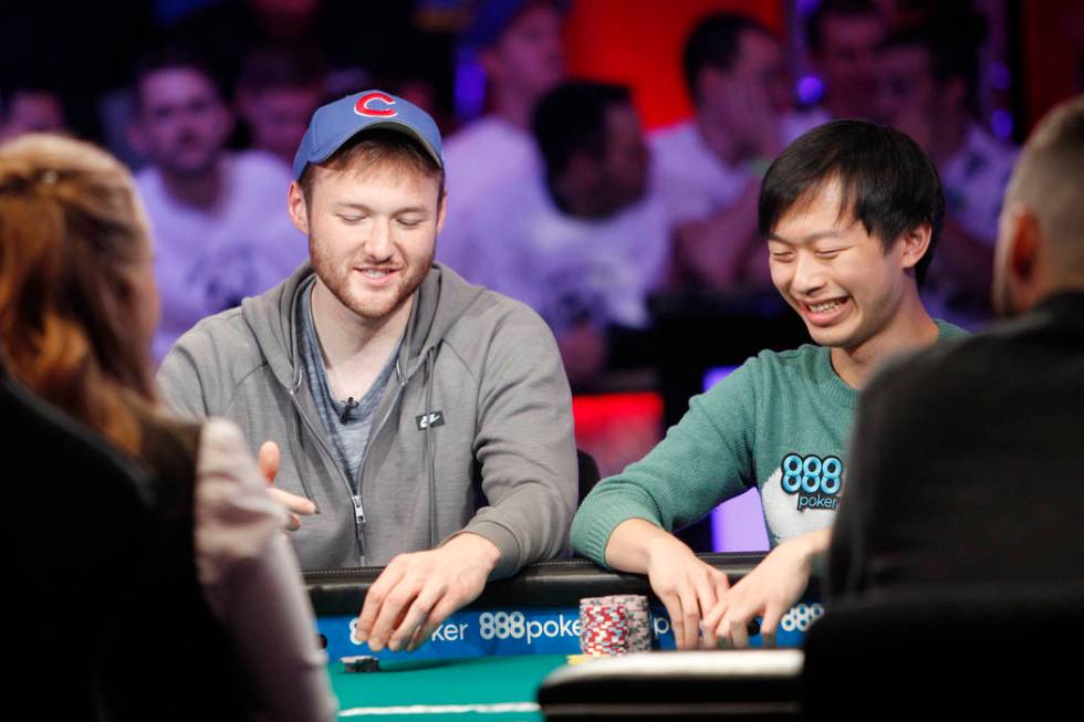 Kevin Maahs, left, talks with Timothy Su at the main event final table during the World Series ...