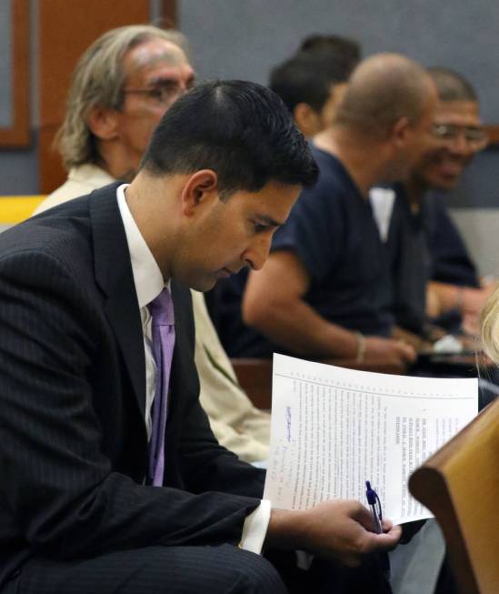 Jay P. Raman, chief deputy district attorney, reviews documents before a hearing at the Regiona ...