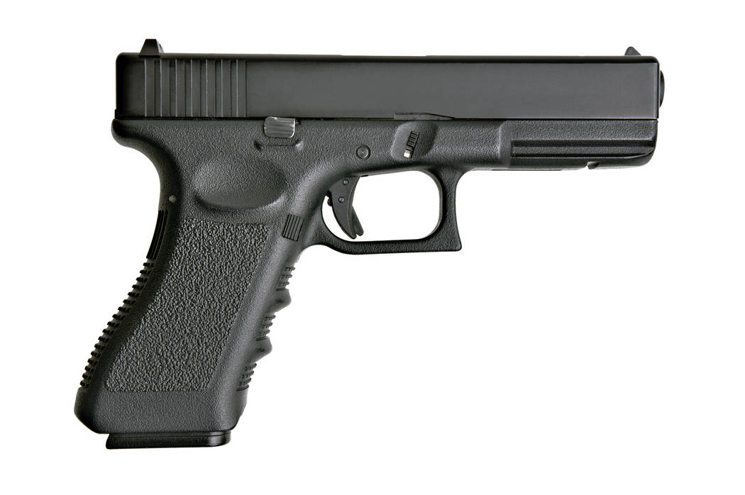 side view of handgun on pure white background