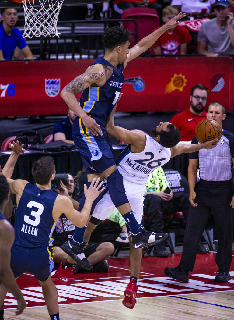 Memphis Grizzlies forward Brandon Clarke, above, gets up high to defend a shot from Minnesota T ...