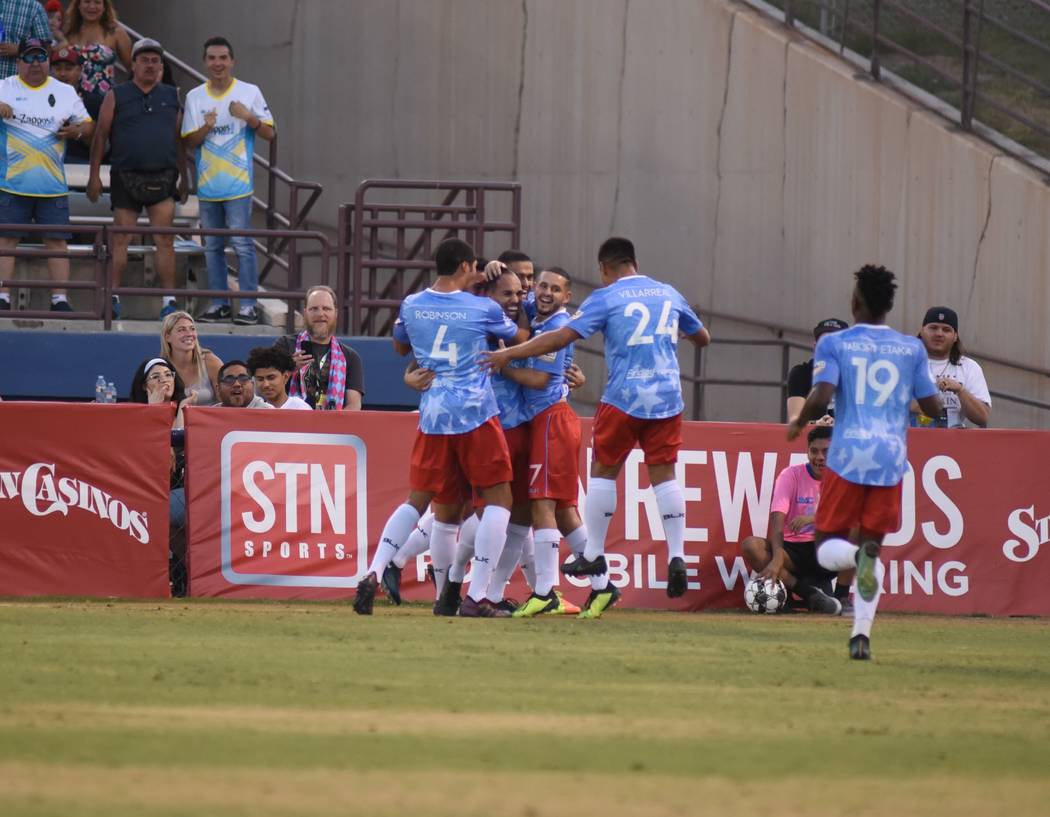 Lights FC players celebrate with Jesus Gonzalez, who scored his first goal on July 4 against LA ...