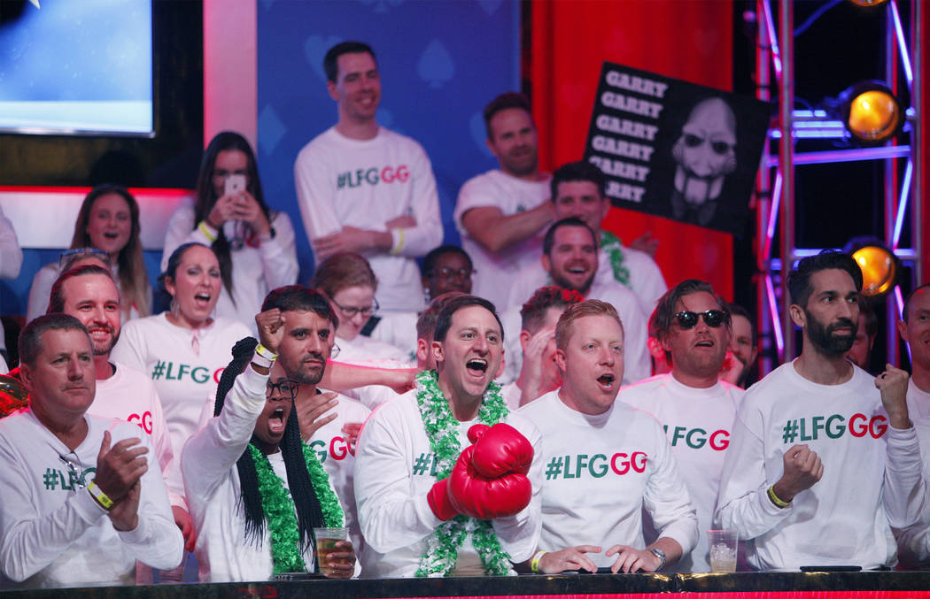 Fans of Garry Gates cheer him on at the main event final table at the World Series of Poker tou ...