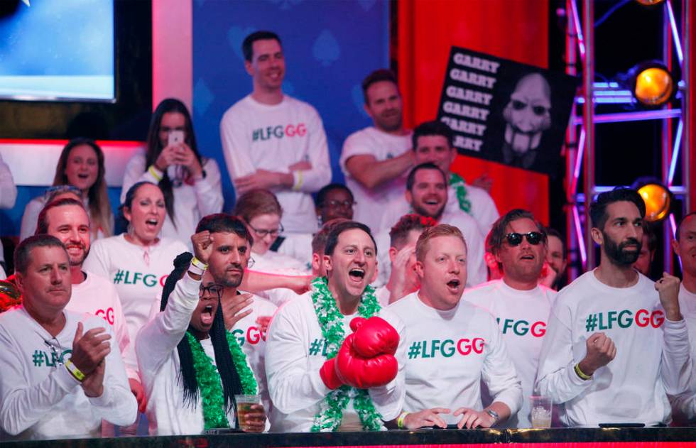 Fans of Garry Gates cheer him on at the main event final table at the World Series of Poker tou ...