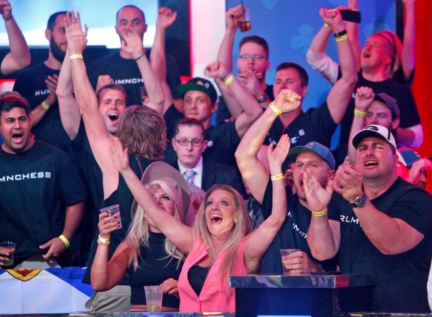 Fans of Alexander Livingston cheer him on at the main event final table at the World Series of ...