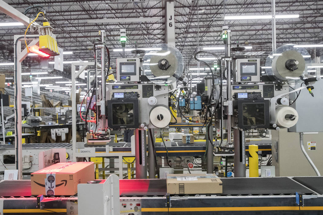 In this Dec. 5, 2018, photo mailing labels are placed on boxes at the Amazon fulfillment center ...