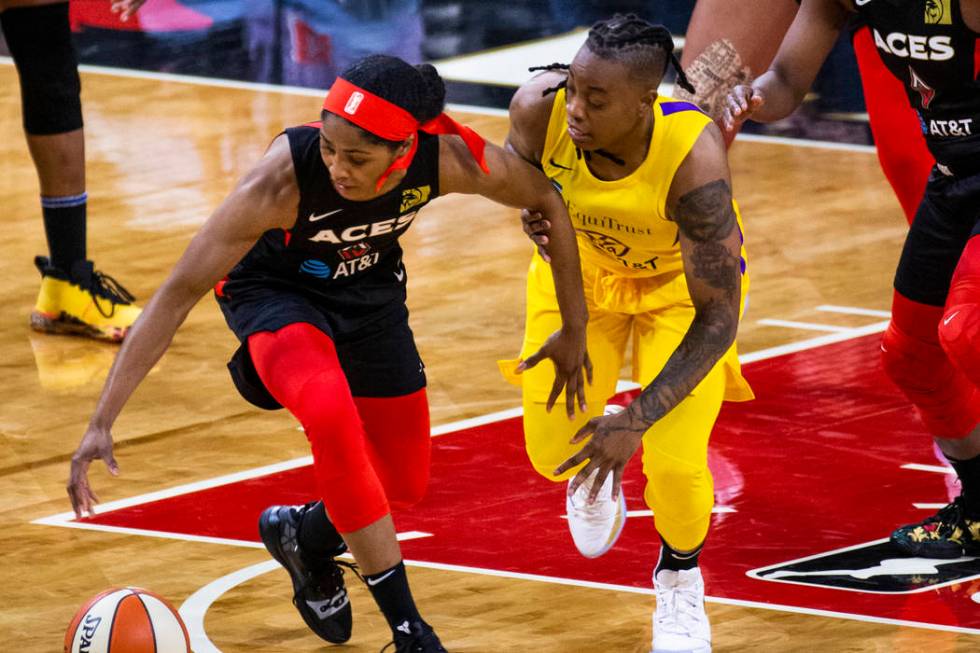 Las Vegas Aces guard Sydney Colson (51) steals the ball from Los Angeles Sparks guard Riquna Wi ...