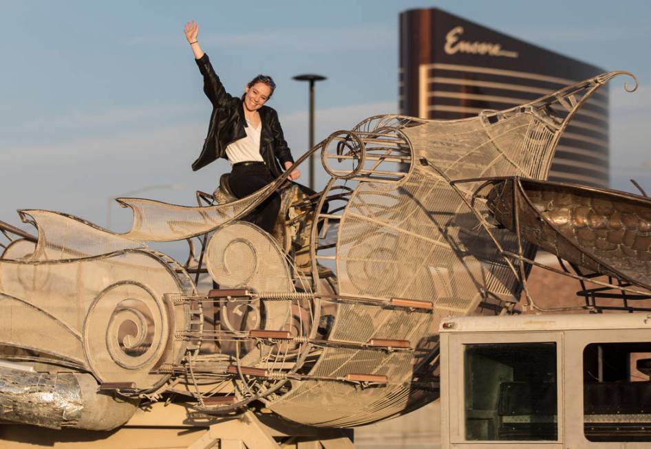 Rose Donahue waves at a friend from the top of the art installation "Balanceville" during the u ...