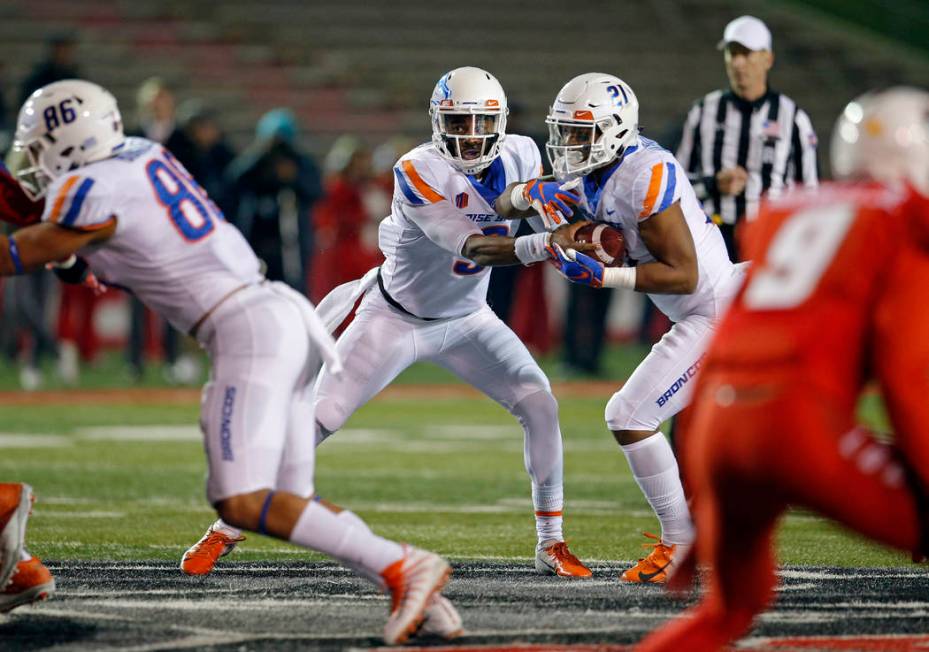 Boise State quarterback Jaylon Henderson (9) feints handing the ball to running back Andrew Van ...