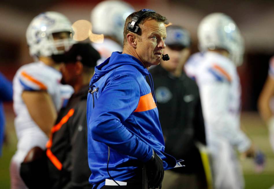 Boise State coach Bryan Harsin talks on his headphones during the second half of an NCAA colleg ...