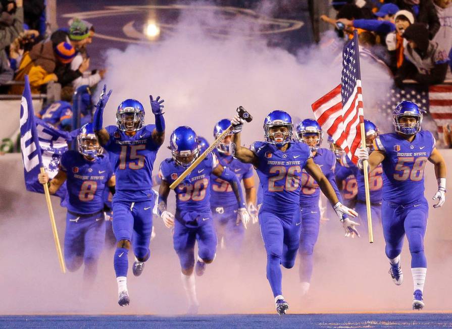 Boise State cornerback Avery Williams (26) carries the hammer as he leads Boise State on to the ...