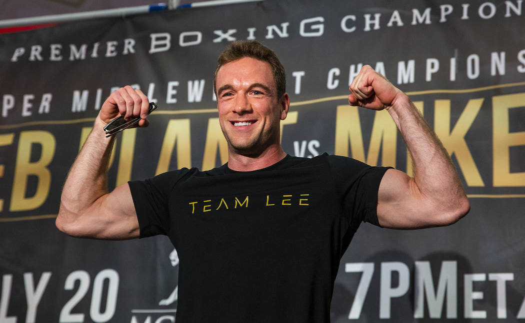 Boxer Mike Lee flexes for the crowd from the stage during fighter grand arrivals at the MGM Gra ...