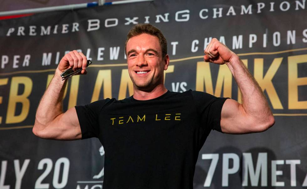 Boxer Mike Lee flexes for the crowd from the stage during fighter grand arrivals at the MGM Gra ...