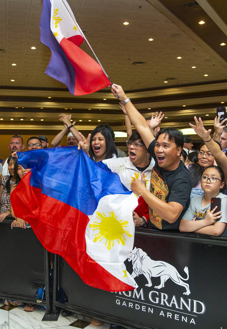 Fans (from left, center) Cherie and Darwin Custodio with Orly Manimtim join others in cheering ...