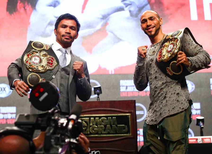 Manny Pacquiao, left, and Keith Thurman pose for pictures during a press conference ahead of th ...