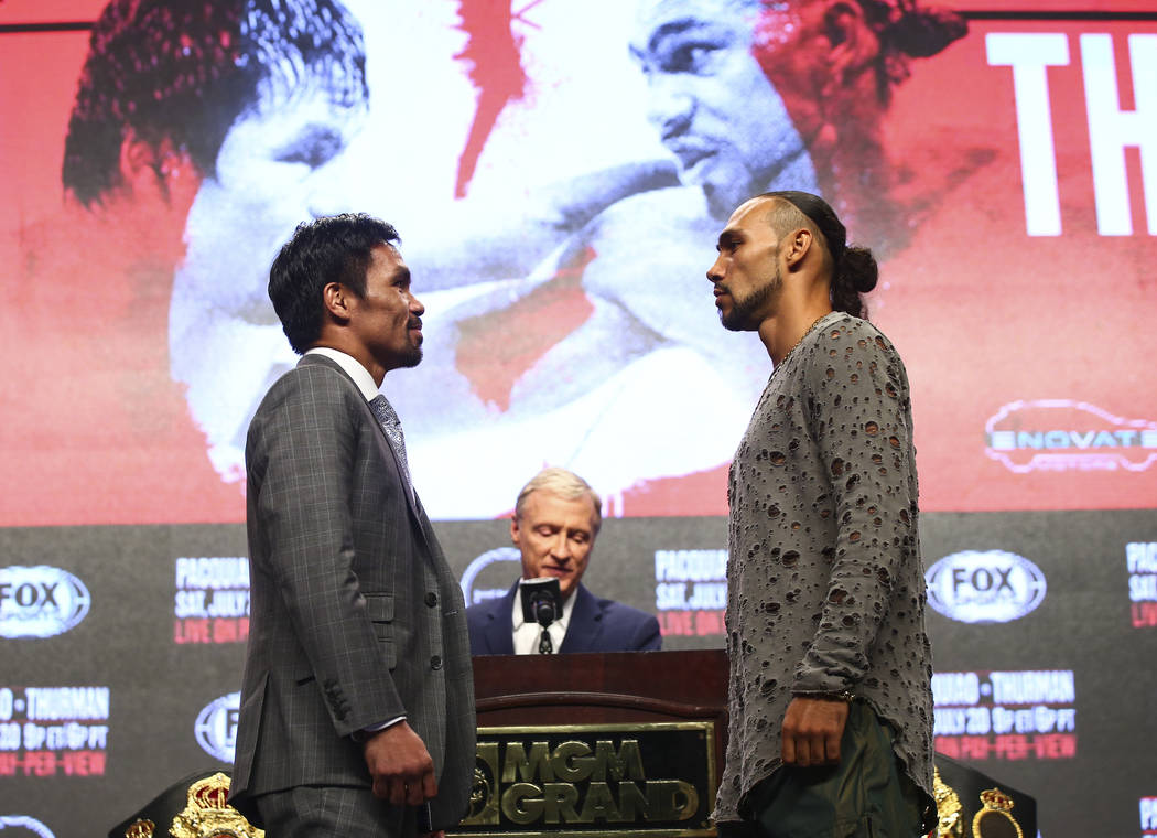 Manny Pacquiao, left, and Keith Thurman pose for pictures during a press conference ahead of th ...