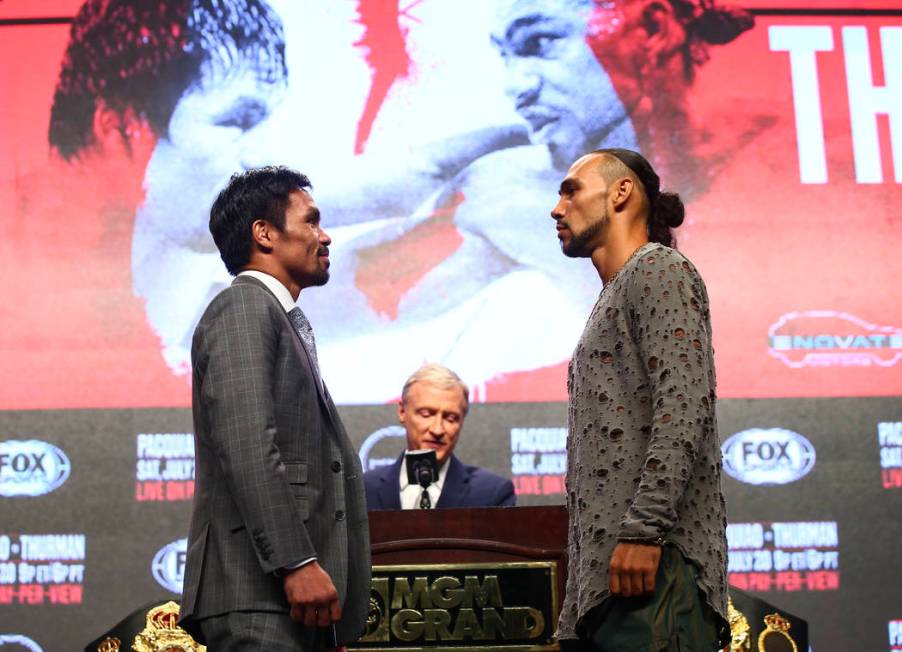 Manny Pacquiao, left, and Keith Thurman pose for pictures during a press conference ahead of th ...