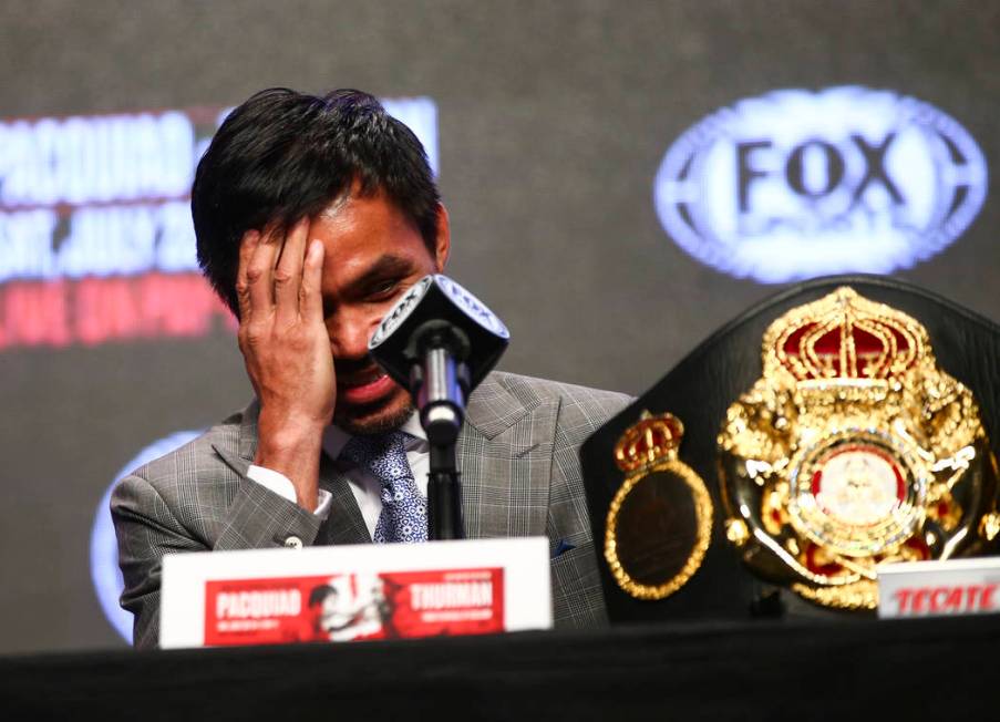 Manny Pacquiao reacts while listening during a press conference ahead of his WBA welterweight c ...