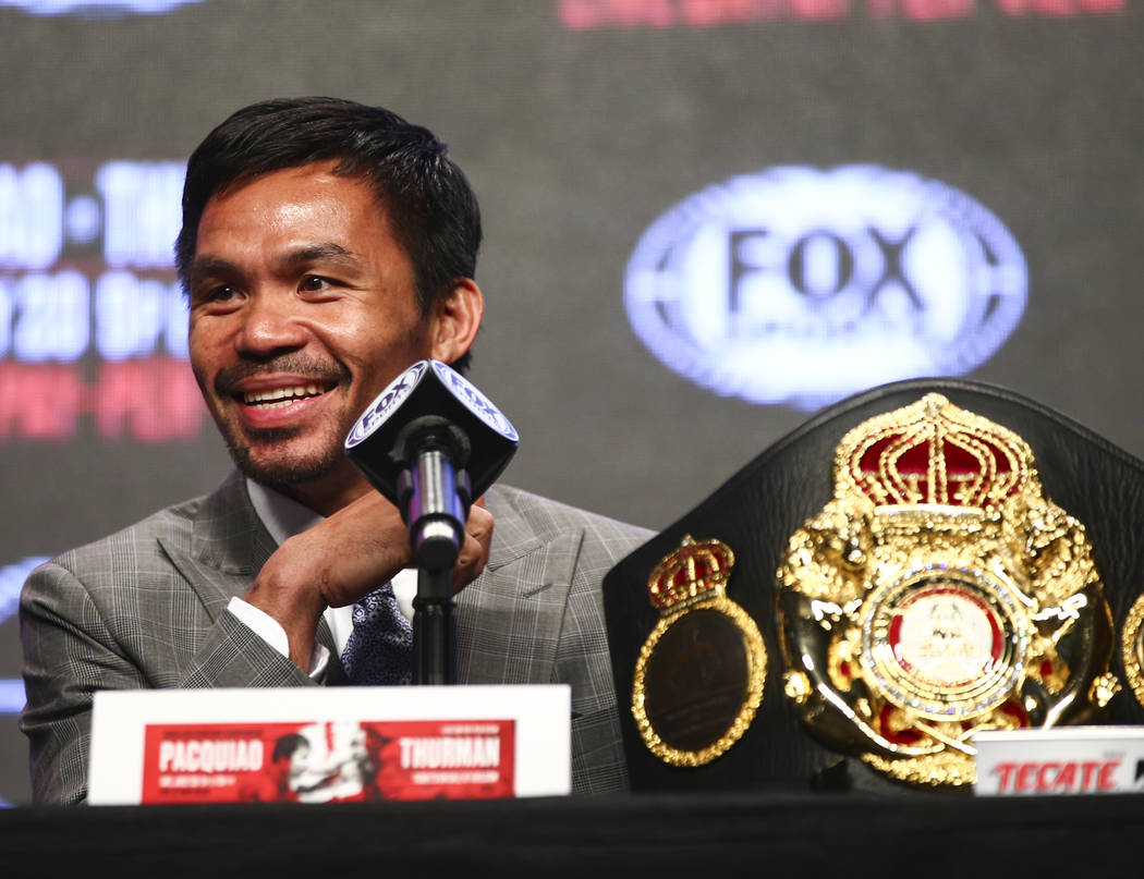 Manny Pacquiao reacts while listening during a press conference ahead of his WBA welterweight c ...