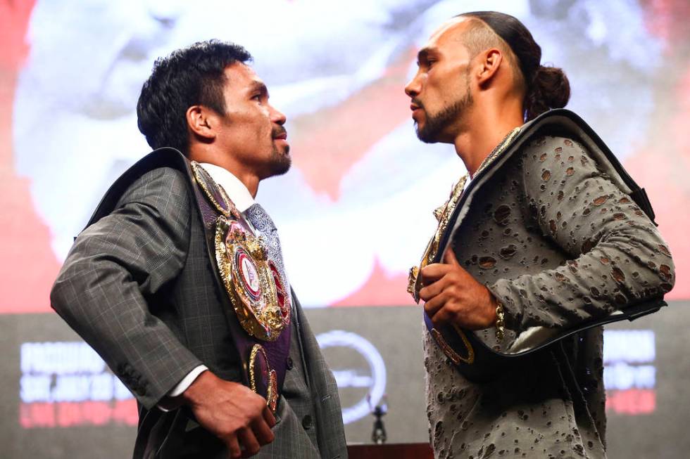 Manny Pacquiao, left, and Keith Thurman pose for pictures during a press conference ahead of th ...