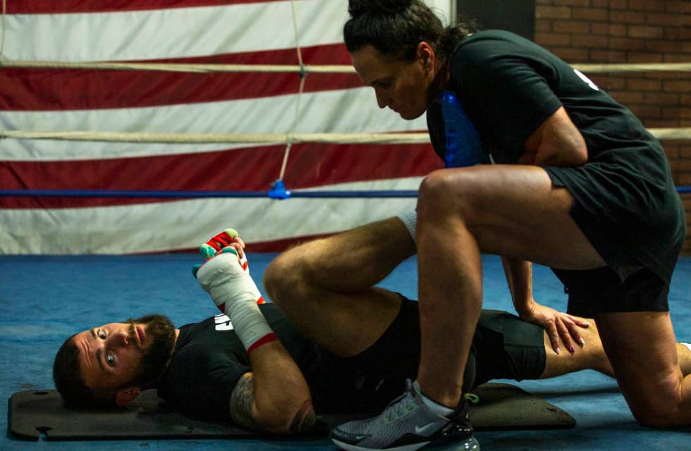 Boxer Caleb Plant, IBF super middleweight champion, left, is stretched out by his masseuse Wieb ...