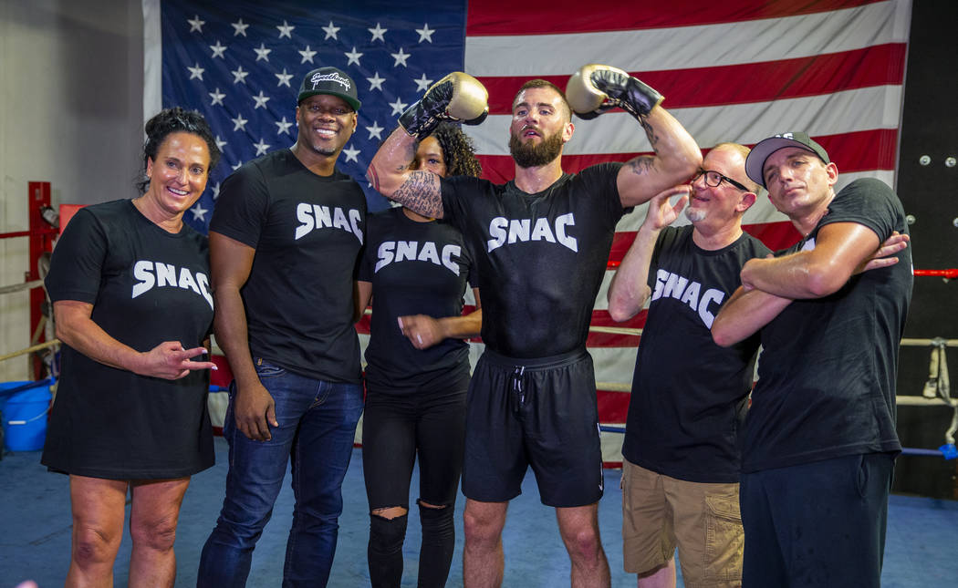 Boxer Caleb Plant, IBF super middleweight champion, center, jokes around during a team picture ...