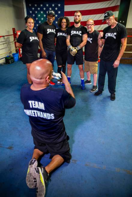 Boxer Caleb Plant, IBF super middleweight champion, center, is flanked by members of his team d ...