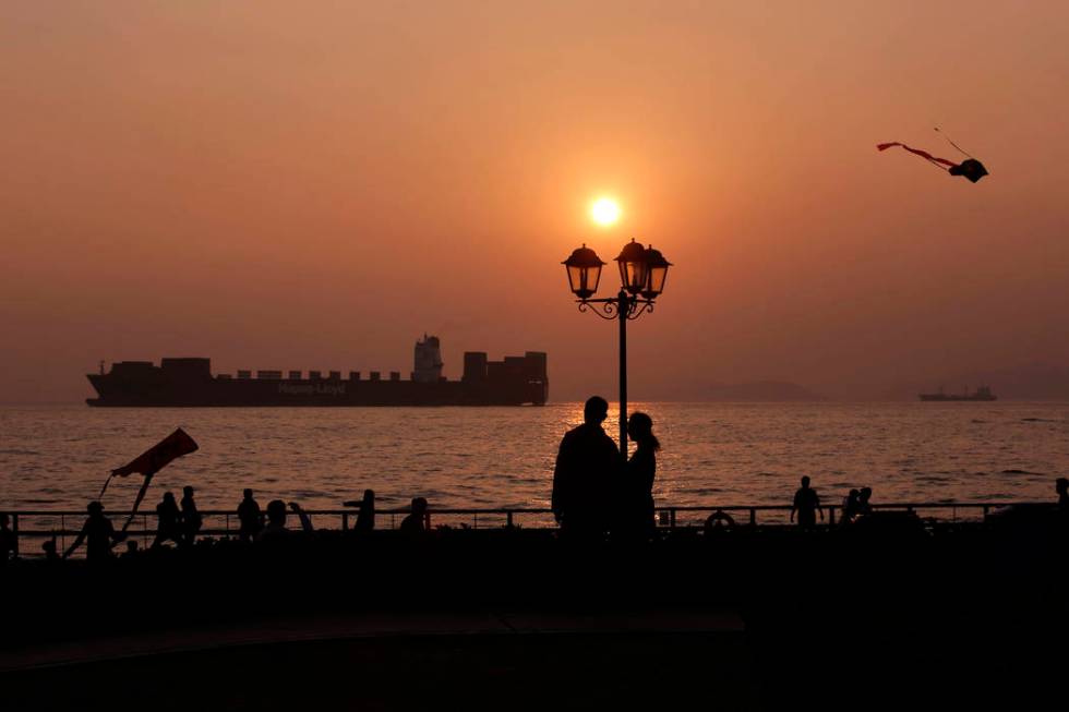 People enjoy their moment during the last sunset of year 2017 at a park in Hong Kong, Sunday, D ...