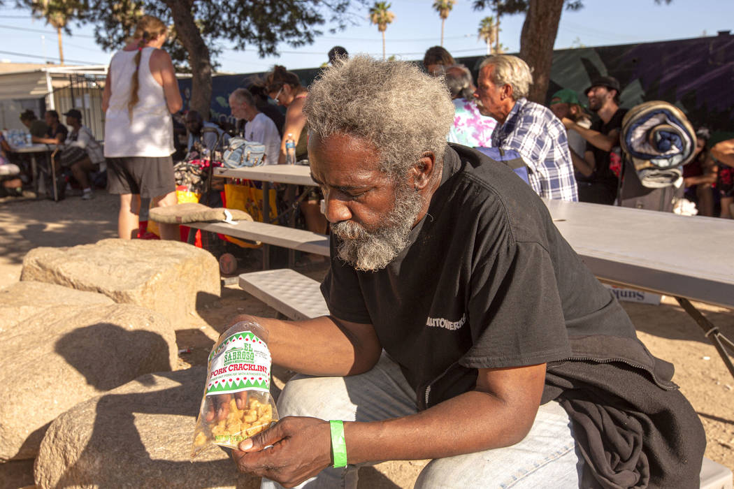 Allen Grayson, 60, from Bakersfield, Calif., eats popcorn before getting in line for a spot on ...